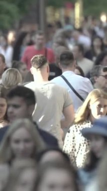 Vertical video of a crowd of people in the city