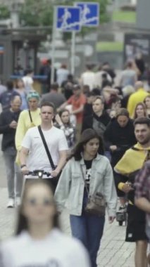 Vertical video of a crowd of people in the city