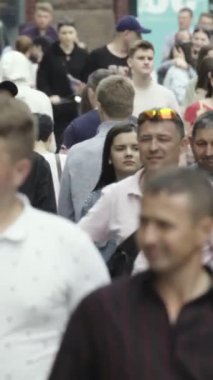 Vertical video of many people in the city