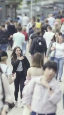 Vertical video of many people in the city