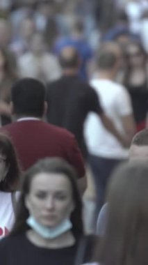 Vertical video of many people in the city