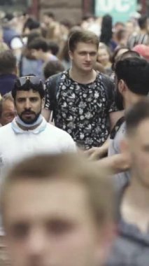 Vertical video of many people in the city