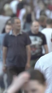 Vertical video of a crowded street