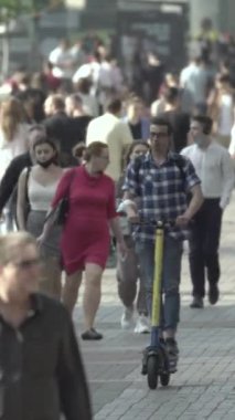 Vertical video of a crowded street