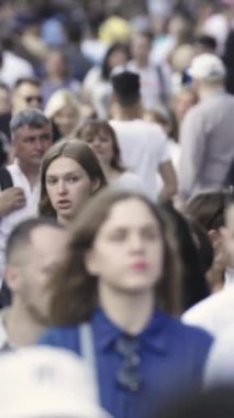 Vertical video of a crowded street
