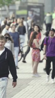Vertical video of a crowded street