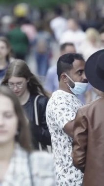 Vertical video of a crowded street