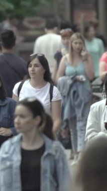 Vertical video of a crowded street