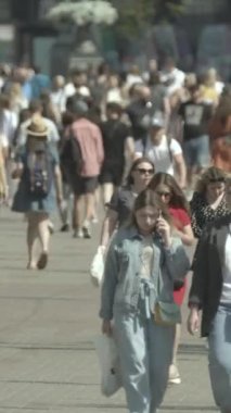 Vertical video of a crowded street