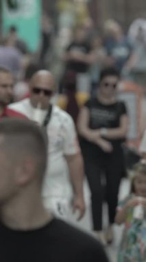 Vertical video of a crowded street