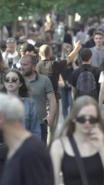 Vertical video of a crowded street
