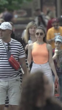 Vertical video of a crowded street