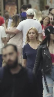 Vertical video of a crowded street