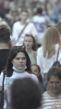 Vertical video of a crowded street