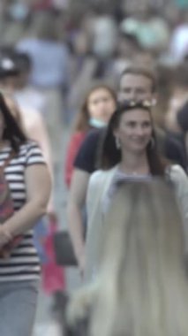Vertical video of a crowded street