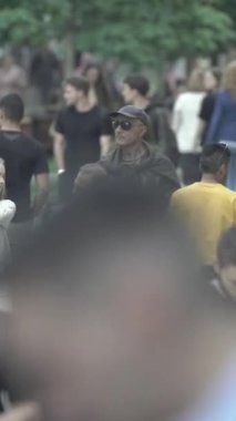 Vertical video of a crowded street