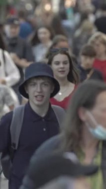 Vertical video of a crowded street