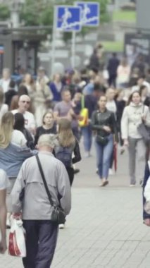 Vertical video of a crowded street