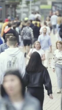 Vertical video of a crowded street in a metropolis