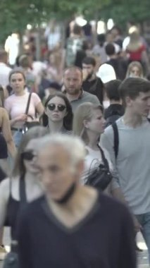 Vertical video of a crowded street in a metropolis
