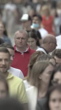 Vertical video of a crowd of people in the city