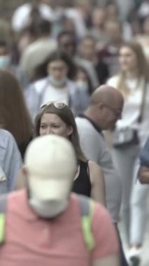 Vertical video of a crowded street in a metropolis