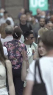 Vertical video of a crowded street in a metropolis