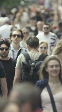 Vertical video of a crowded street in a metropolis