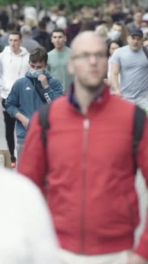 Vertical video of a crowded street in a metropolis