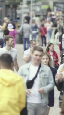 Vertical video of a crowded street in a metropolis