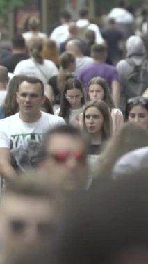 Vertical video of a crowded street in a metropolis