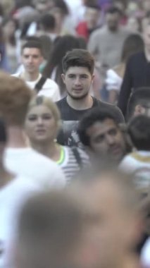 Vertical video of a crowded street in a metropolis