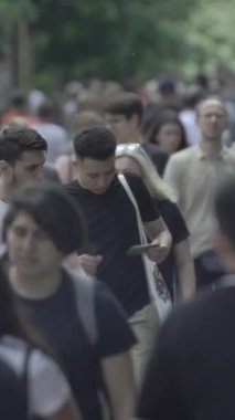Vertical video of a crowded street in a metropolis