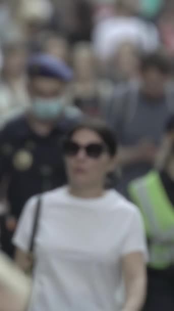 Vertical video of pedestrians walking along a city street — Stock Video