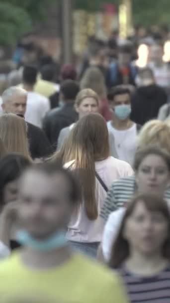 Vertical video of pedestrians walking along a city street — Video