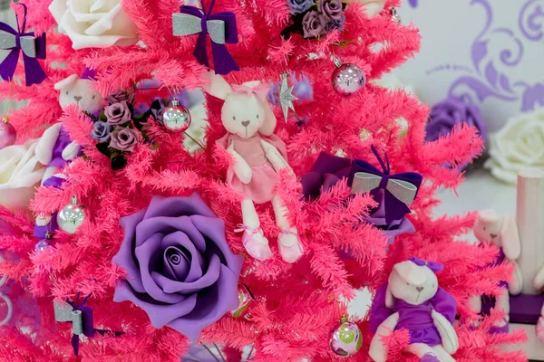 Pink Christmas tree with roses and plush bunnies. New Year at the ballet school.