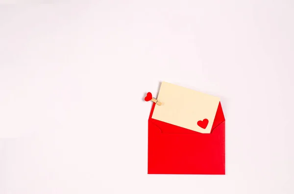 Greeting card with a red envelope with romantic hearts on a white background. — Stock Photo, Image