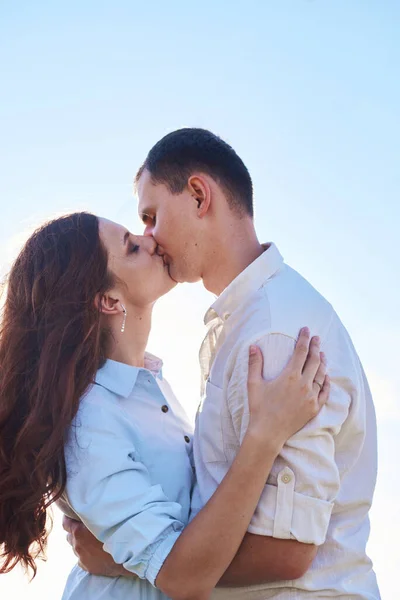 Couple élégant et moderne s'embrassant dans un champ de blé. Une jeune femme étreint son petit ami et s'embrasse. Le concept de passion et d'amour — Photo