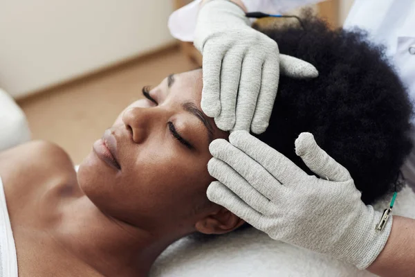 Face rejuvenation with the help of microcurrent therapy. Lymphatic drainage massage. Micro sensory electrical BIO EMS microcurrent treatment for face and body electro stimulation and muscle toning.