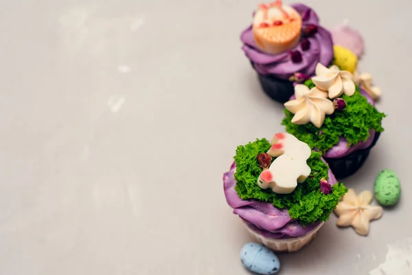 Easter food concept. Idea for kids. Decorating Easter bunny cupcakes with meringues Royalty Free Stock Photos