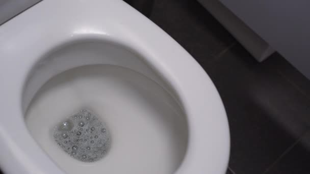 Das Wasser spült die Toilette. Entleerung einer Keramik-Toilette an einem öffentlichen Ort — Stockvideo