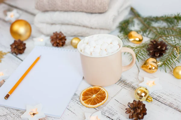 Christmas background, Notepad with pencil, coffee mug and marshmallows , Golden Christmas tree toys . Letter To Santa Claus. Merry Christmas greeting card