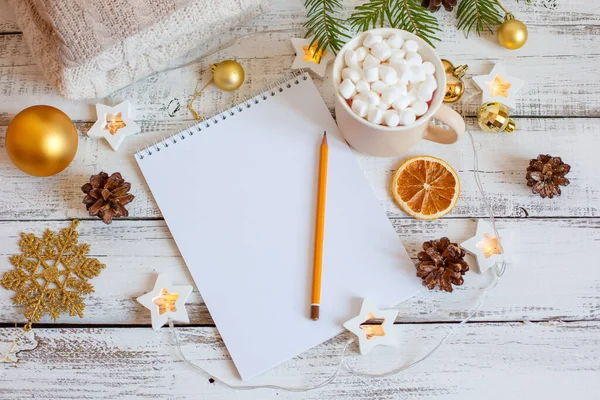 Christmas background, Notepad with pencil, coffee mug and marshmallows , Golden Christmas tree toys . Letter To Santa Claus. Merry Christmas greeting card