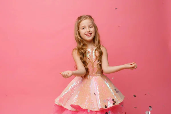 Happy Little Girl Catches Confetti Pink Background Holiday Concept — Stock Photo, Image