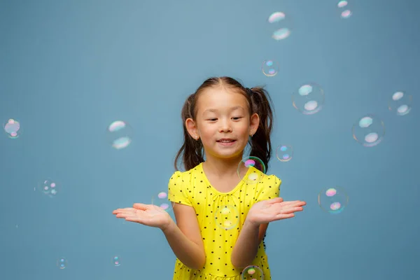 Asian Girl Playing Soap Bubbles Studio Blue Background — Stock Photo, Image