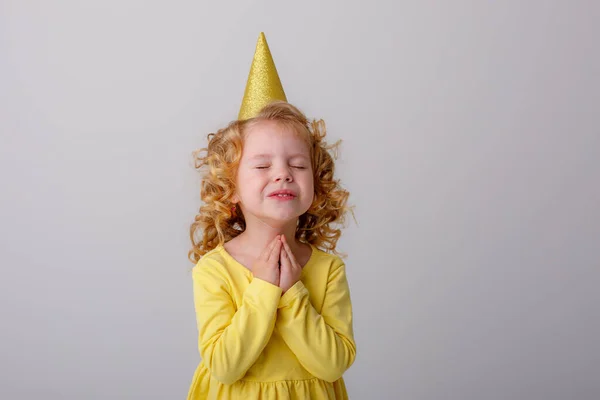 Κοριτσάκι Κίτρινο Φόρεμα Καπέλο Γενεθλίων Ποζάροντας Γκρι Φόντο — Φωτογραφία Αρχείου