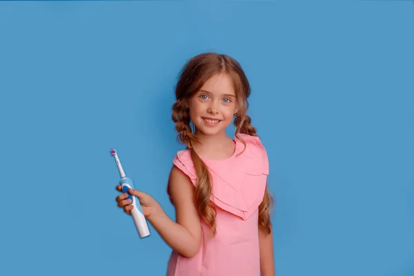 Little Girl Holding Electric Toothbrush Blue Background — Stock Photo, Image