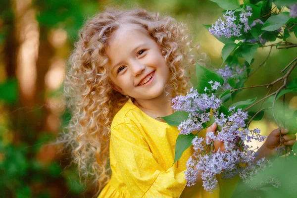 Mooi Klein Meisje Poseren Lila Bloemen — Stockfoto