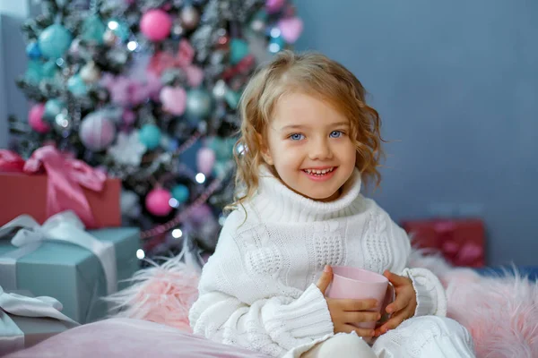 Una Bambina Vicino All Albero Natale Che Tiene Una Tazza — Foto Stock