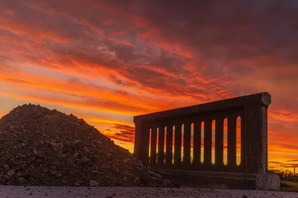 その上に素晴らしい夕日の空を持つ古い橋の壁のセクション — ストック写真
